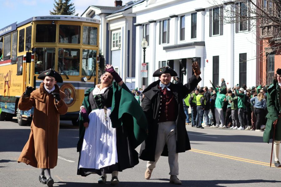 People dressed in colonial-style costumes wave to the crowd at Sunday's St. Patrick's Day parade.