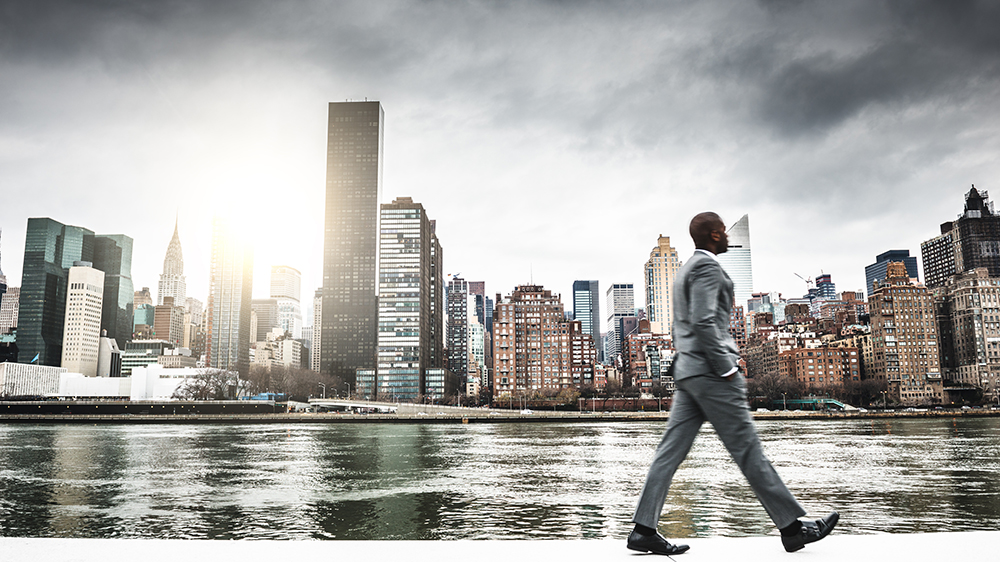 Successful business man looking away against the skyline