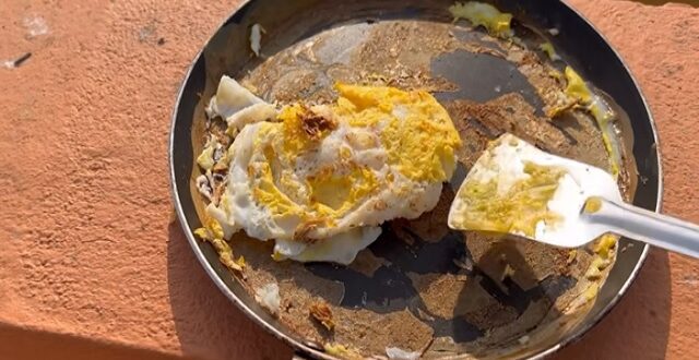 Man fries egg on terrace during heatwave.