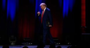 Trump enters rally as 'prison-bound' song blares.