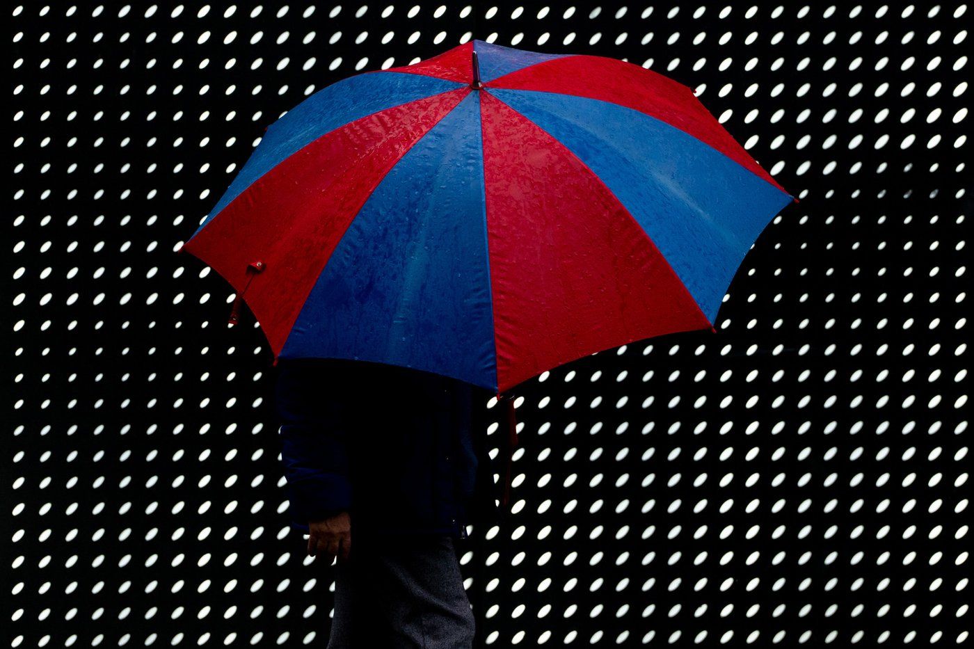 A person walks with an umbrella on a rainy day in Vancouver, on Saturday, January 4, 2025. THE CANADIAN PRESS/Ethan Cairns